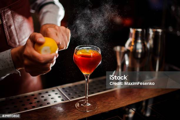 Bartender Is Adding Lemon Zest To The Cocktail At Bar Counter Selective Focus Stock Photo - Download Image Now