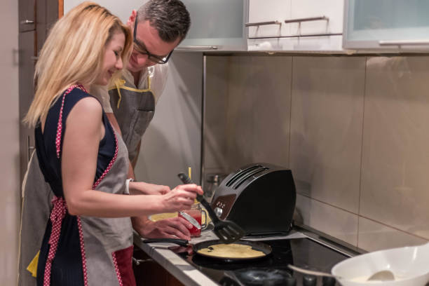 istock Wife making pancakes in modern kitchen 839900554