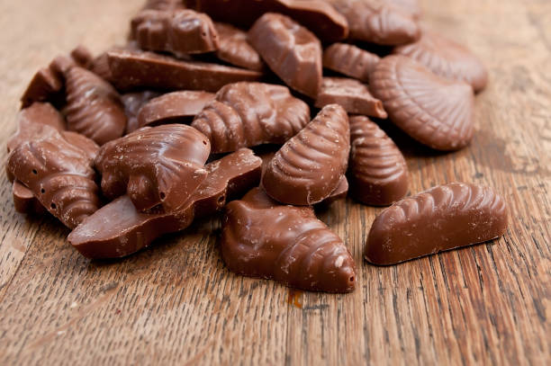 istock shell-shaped chocolates pralines assortment on wooden table 839900852