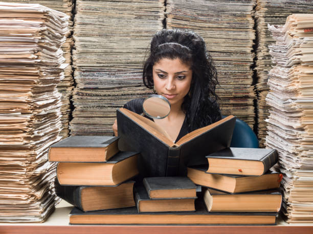 istock Young Mixed Race Woman Doing Research In Library 839900860
