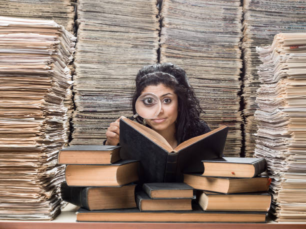 istock Young Mixed Race Woman Doing Research In Library 839900878