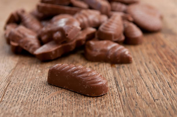 istock shell-shaped chocolates pralines assortment on wooden table 839901024