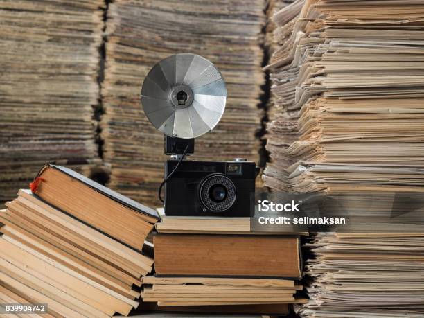 Camera Seen On Large Amount Of Documents Newspapers Magazines And Books Stock Photo - Download Image Now