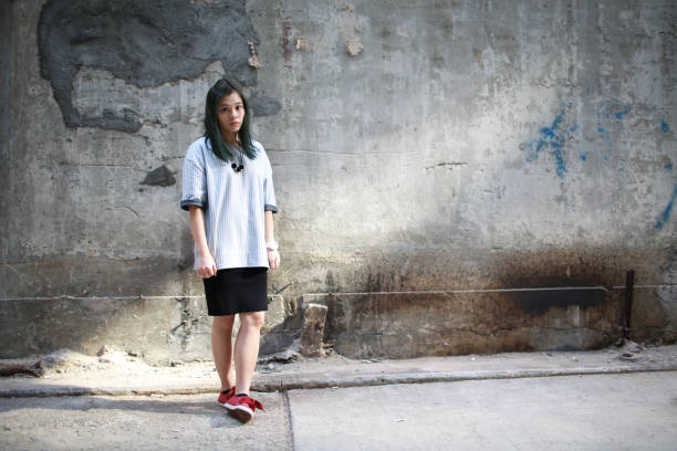 istock girl with the concrete wall background 839910962