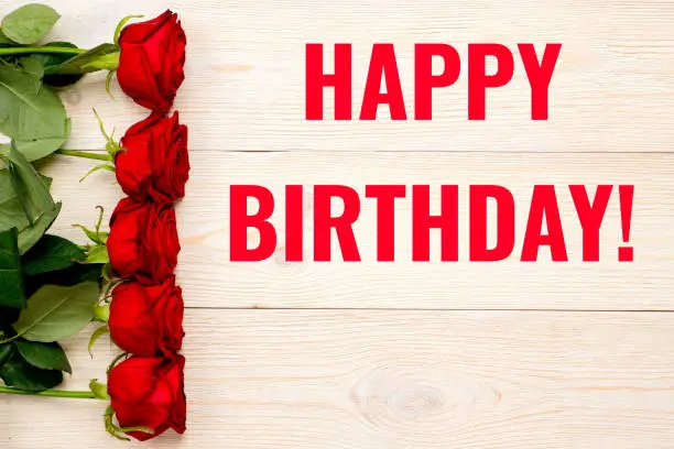 happy birthday card with red roses over wooden planks