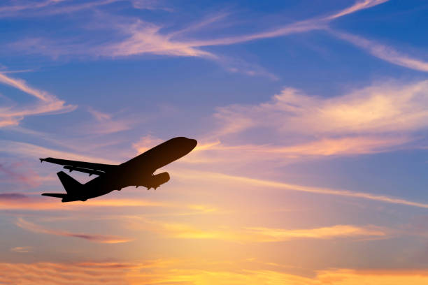 istock Silhouette passenger airplane flying away in to sky during sunset 839918740