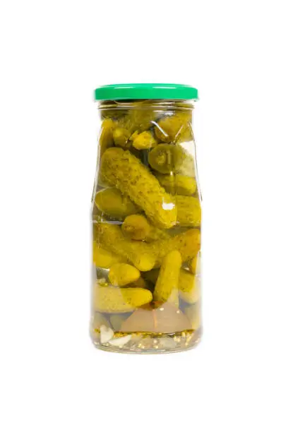 pickled cucumbers in glass jar isolated on white