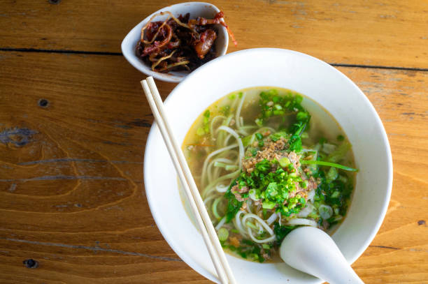 istock Noodles with minced pork in white bowl on wood table. Top view 839931924