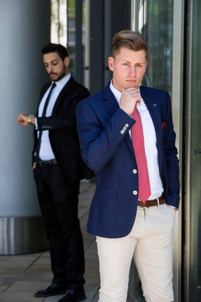 istock two businessmen standing outside and waiting 839935388
