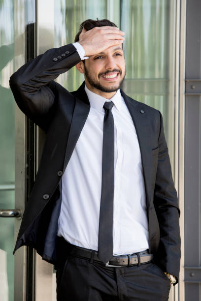 istock businessman standing outside with a headache 839935696