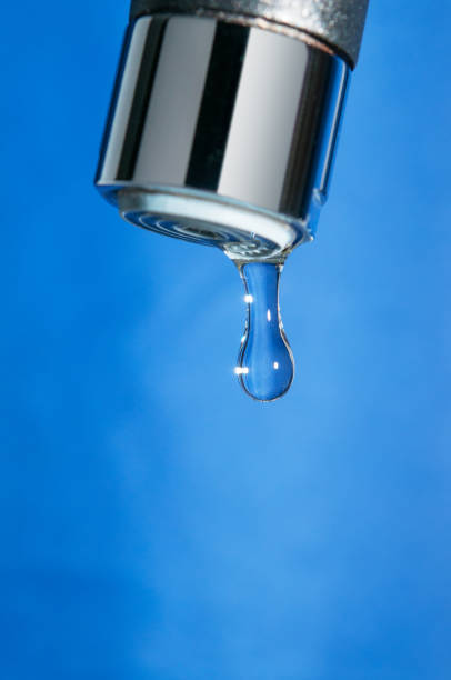 istock Modern tap and water drop on blue background 839938006