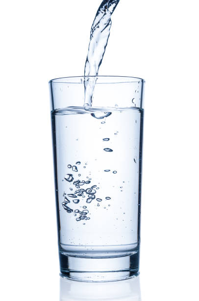 istock Pouring water into glass on white background 839938516