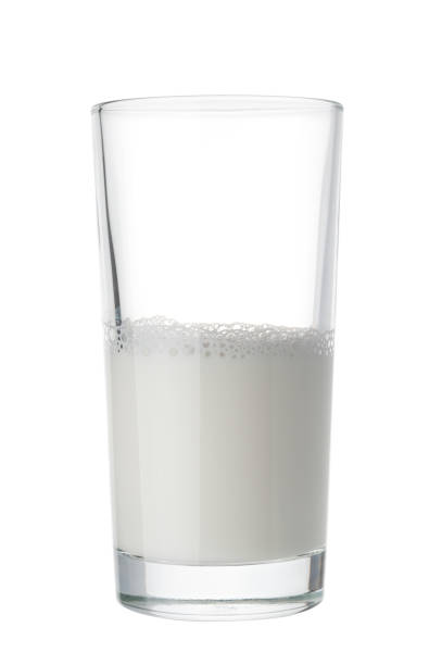 Half a glass of milk on white background