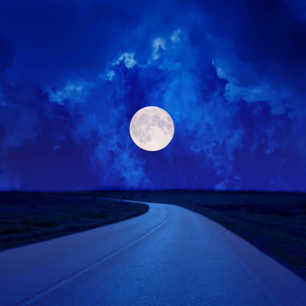 istock full moon in clouds over asphalt road 839944080