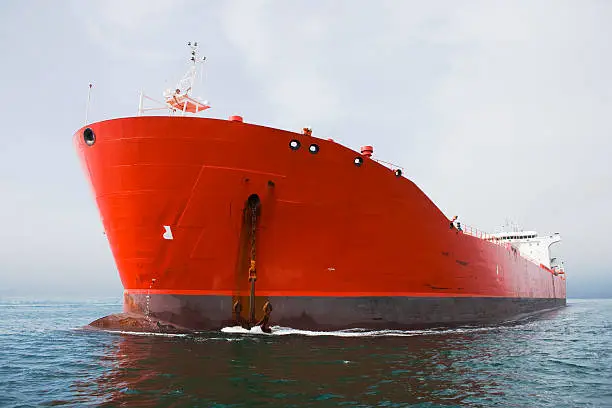 Photo of Bow view of red tanker.