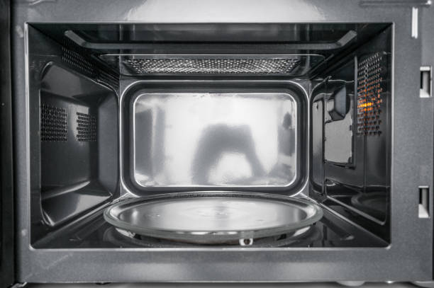 Inside view of clean, empty microwave Inside view of clean, empty microwave inside microwave stock pictures, royalty-free photos & images