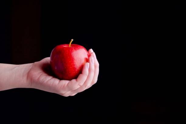 istock An red apple holding in hand 839958160