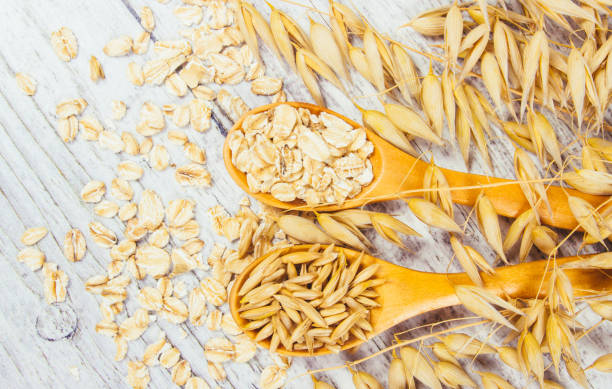 istock Raw oat flakes on a wooden table - closeup. 839958798