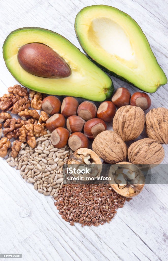 Sources of omega 3 fatty acids contained in the food. Sources of omega 3 fatty acids: flaxseeds, avocado, walnuts and sunflower. Acid Stock Photo