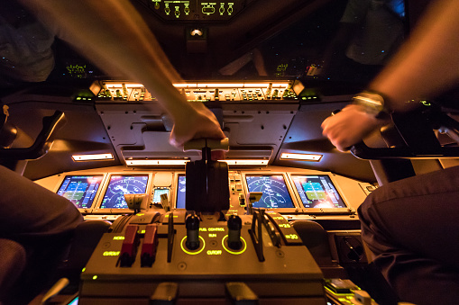 Two pilots at work after departure of Amsterdam International Airport Netherlands. The view from the flight deck with high workload