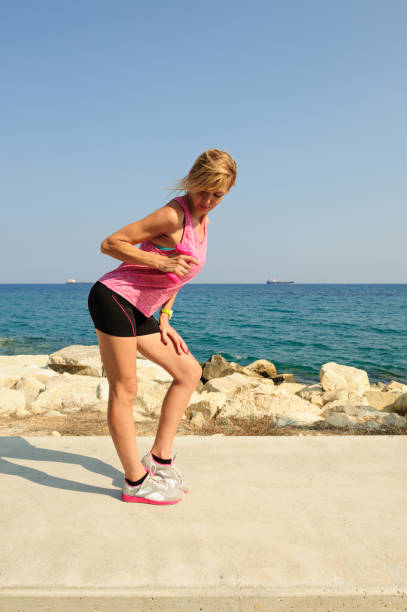 istock Young athletic woman exercising outdoors: tricep extensions for upper body strength 839966178