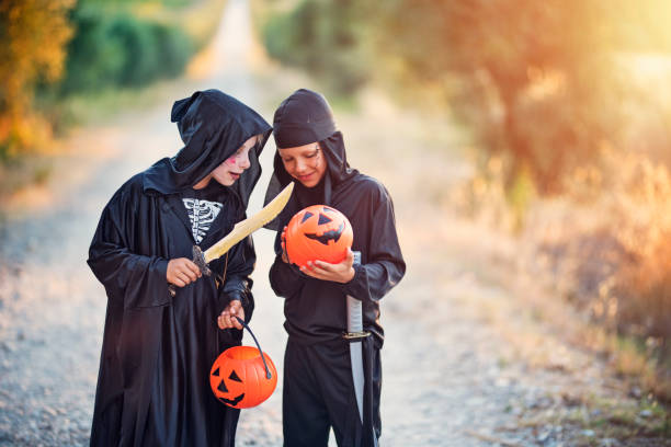 istock Little halloween boys comparing amount of candy 839990148