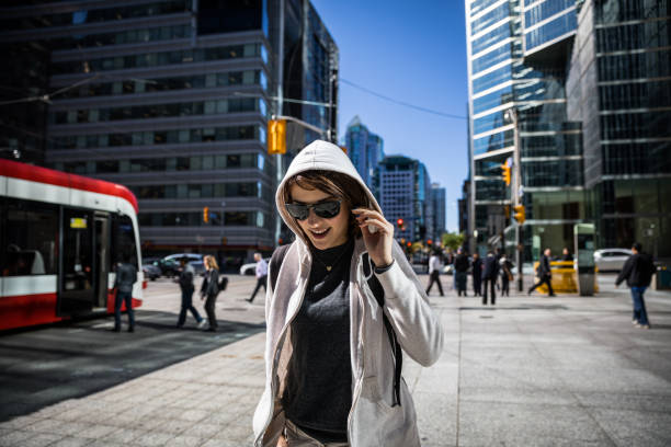 istock Young woman walking in downtown Toronto 839992660