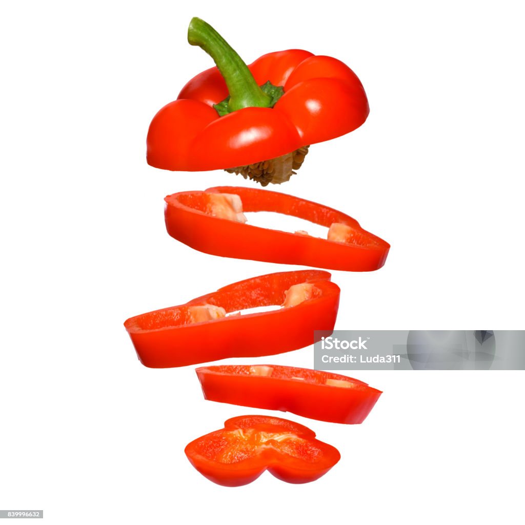 Creative concept with flying red paprika. Sliced floating pepper isolated. Creative concept with flying red paprika. Sliced floating pepper isolated. Levity vegetable. Capsicum Bell Pepper Stock Photo