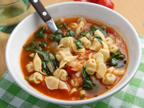 Tomato tortellini spinach soup stock photo