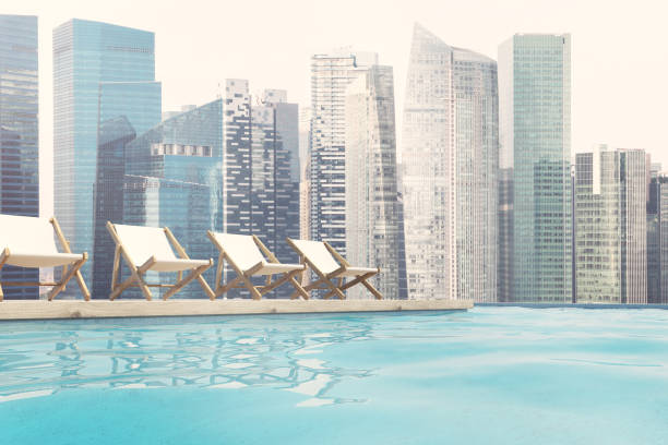 istock Row of white deck chairs, cityscape 840002194