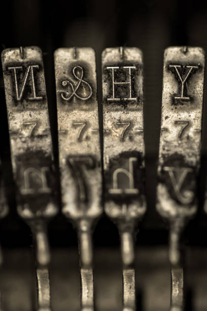 Macro image of manual typebar Macro image of manual typebar of manual typewriter, with selective focus on N, H, Y, & and 7. typewriter writing retro revival work tool stock pictures, royalty-free photos & images