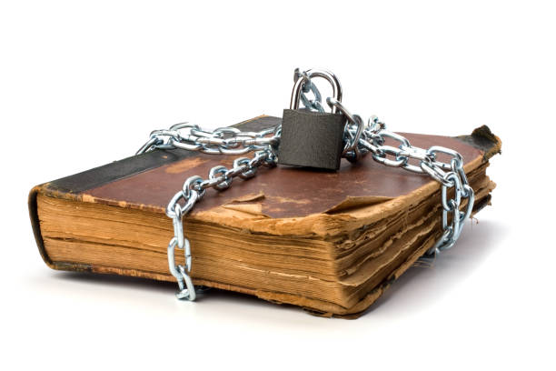 istock tattered book with chain and padlock isolated on white backgroun 840027854
