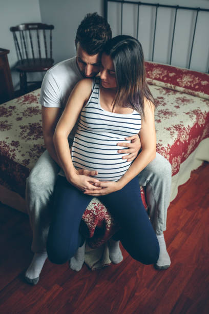 istock Pregnant woman embraced by her husband 840027902