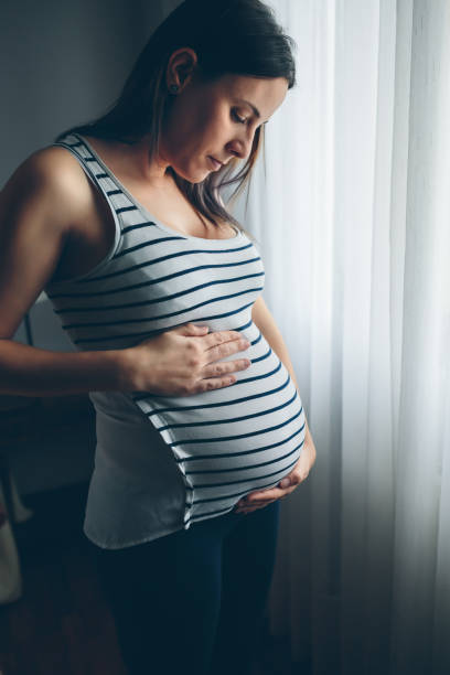 istock Pregnant woman looking her belly 840027956