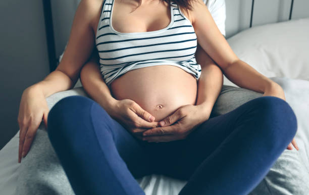 istock Pregnant woman embraced by her husband 840034416