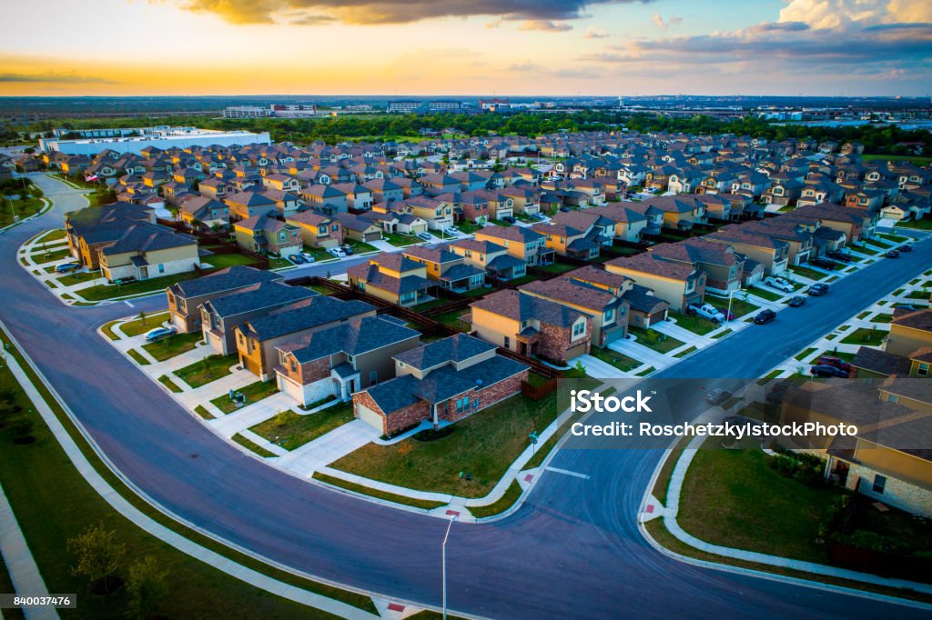 Sunset above Suburb aerial drone view high above homes in Austin Texas Suburb aerial drone view high above homes in Austin Texas thousands of homes into the distance Aerial View Stock Photo