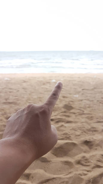 istock Man hand is pointing to the sea beach 840037920