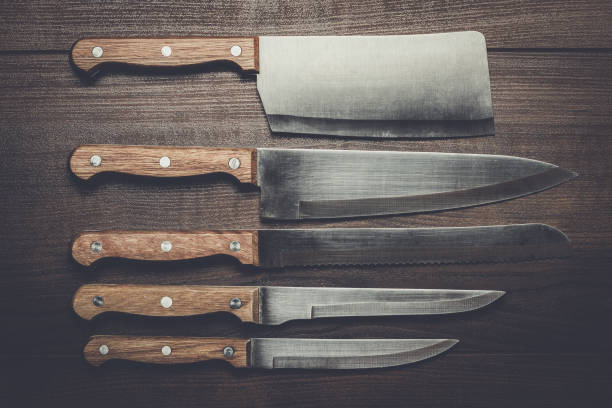 istock kitchen knifes over brown wooden table 840041390