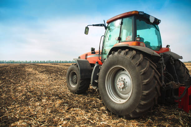 istock Modern red tractor in the field. 840044370