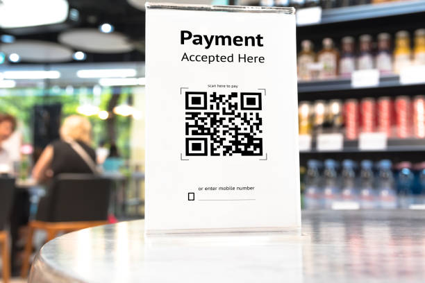 istock Qr code payment , online shopping , cashless technology concept. Coffee shop accepted digital pay without money , plastic tag on table. 840044570