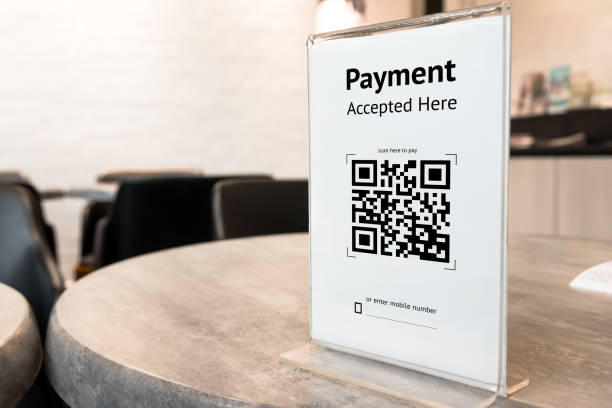 istock Qr code payment , online shopping , cashless technology concept. Coffee shop accepted digital pay without money , plastic tag on table. 840044574