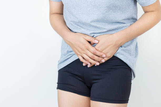 istock Young woman feeling unwell with a stomach ache on white background. 840056646