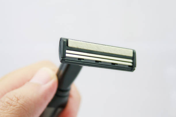 istock Hand with shaving razor isolated on a white background 840057110