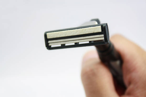 istock Hand with shaving razor isolated on a white background 840057122