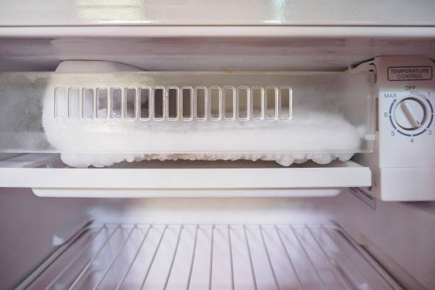 istock frozen Ice buildup in the freezer of refrigerator 840057178