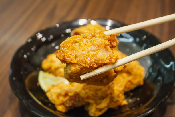 istock fried chicken Japanese style in chopsticks 840060946