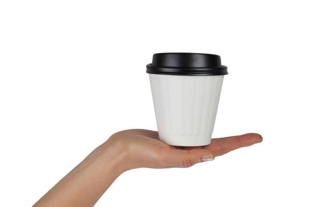 istock Female hand with white disposable coffee cup in the palm isolated on white with copy space 840063852
