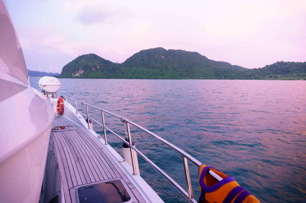Beautiful tree and fog covered islands as seen from the deck of a modern ship in Langkawi. The beautiful purple light and colors make this a perfect vacation shot