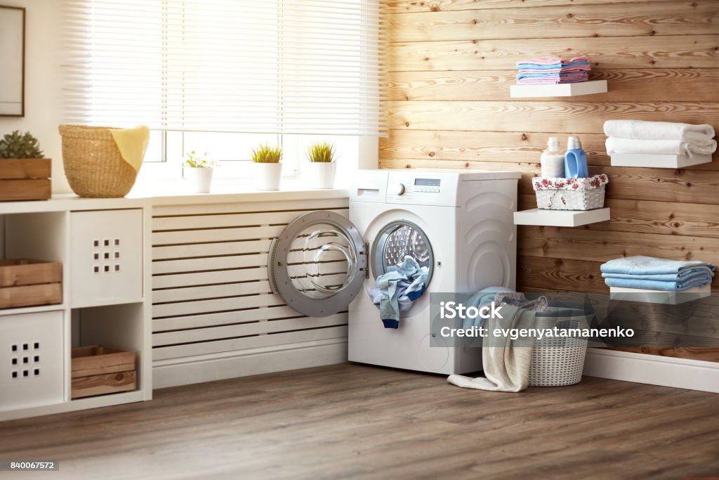 Interior of real laundry room with  washing machine at window at home Interior of a real laundry room with a washing machine at the window at home Laundry Stock Photo