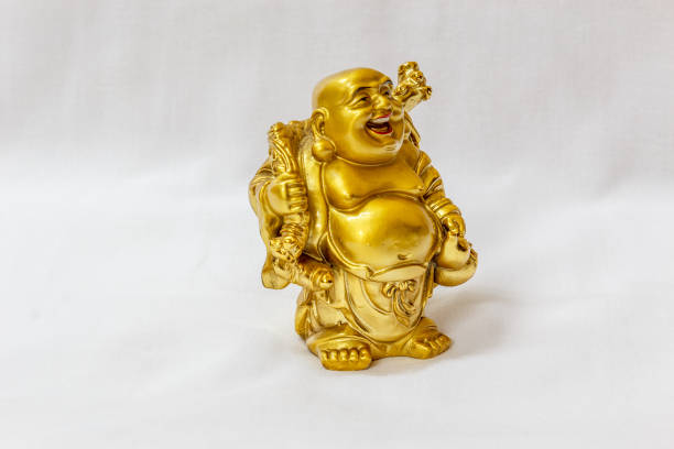 istock Laughing Buddha painted in gold colour with white backdrop 840068578